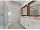 Modern bathroom featuring a glass-enclosed shower and double vanity with framed mirrors at 173 Rehoboth Ln, Mooresville, NC 28117