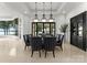 Formal dining room with modern light fixtures, elegant chairs, and a view of the water at 173 Rehoboth Ln, Mooresville, NC 28117