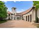 Stunning home exterior featuring a private tower, brick driveway, and a three-car garage at 173 Rehoboth Ln, Mooresville, NC 28117