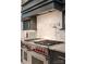Close up of modern stove with gray countertops and a white backsplash at 173 Rehoboth Ln, Mooresville, NC 28117