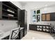 A spacious laundry room with dark cabinets, a workspace, and a view at 173 Rehoboth Ln, Mooresville, NC 28117