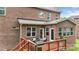 Backyard featuring a deck with outdoor seating, surrounded by a brick house at 1830 Alden Oaks Ln, Charlotte, NC 28270