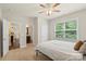 Bedroom with neutral paint, carpet, large window, ceiling fan and attached bath at 1830 Alden Oaks Ln, Charlotte, NC 28270