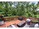 Relaxing deck with a fire pit, outdoor seating, and wooded views at 1830 Alden Oaks Ln, Charlotte, NC 28270