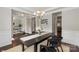 Sophisticated dining room with dark wood table, modern art, and stylish light fixture at 1830 Alden Oaks Ln, Charlotte, NC 28270