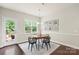 Dining room with hardwood floors, modern chandelier, and access to the deck at 1830 Alden Oaks Ln, Charlotte, NC 28270