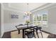 Elegant dining room featuring a modern chandelier, wainscoting, and large window at 1830 Alden Oaks Ln, Charlotte, NC 28270