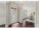 Elegant foyer with dark wood floors leading to an office space with french doors at 1830 Alden Oaks Ln, Charlotte, NC 28270