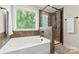 Luxury bathroom with a soaking tub, a walk-in shower, and a large window at 1830 Alden Oaks Ln, Charlotte, NC 28270