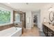 Main bathroom with tub, walk-in shower, and stone floors at 1830 Alden Oaks Ln, Charlotte, NC 28270