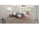 Bright main bedroom with carpet, a ceiling fan, and a king size bed at 1830 Alden Oaks Ln, Charlotte, NC 28270