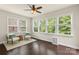 Bright sunroom with hardwood floors, a ceiling fan, and multiple windows with wooded views at 1830 Alden Oaks Ln, Charlotte, NC 28270