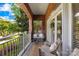 Relaxing balcony with neutral furniture, wood-look flooring, and views of lush greenery at 1903 Kenilworth Ave # 104A, Charlotte, NC 28203