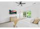 Bright bedroom with a ceiling fan, natural light from a large window and soft carpeted floors at 1903 Kenilworth Ave # 104A, Charlotte, NC 28203