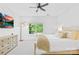 Bright bedroom with a ceiling fan, natural light from a large window and soft carpeted floors at 1903 Kenilworth Ave # 104A, Charlotte, NC 28203