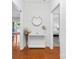 Bright foyer with hardwood floors, a decorative table, and views into the living room and bedroom at 1903 Kenilworth Ave # 104A, Charlotte, NC 28203