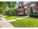 Beautiful brick building with well-maintained landscaping, manicured shrubs, and lush green grass at 1903 Kenilworth Ave # 104A, Charlotte, NC 28203