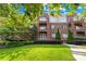 Beautiful brick condo building featuring manicured lawn, mature landscaping, and private balconies at 1903 Kenilworth Ave # 104A, Charlotte, NC 28203