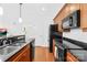 Well-equipped kitchen with black appliances, wood cabinets and laminate flooring at 1903 Kenilworth Ave # 104A, Charlotte, NC 28203