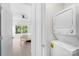 Modern stacked washer and dryer set in a laundry area next to an open doorway looking into a bedroom at 1903 Kenilworth Ave # 104A, Charlotte, NC 28203
