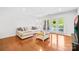 Bright living room featuring hardwood floors and access to a private balcony at 1903 Kenilworth Ave # 104A, Charlotte, NC 28203