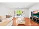 Bright living room with hardwood floors, comfortable seating, and French doors to balcony at 1903 Kenilworth Ave # 104A, Charlotte, NC 28203