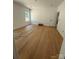 A bright bedroom showcases hardwood floors, neutral walls, and a window with natural light at 1923 Fairfield Rd, Mount Gilead, NC 27306