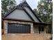 Beautiful new home features stone and siding, with a two-car garage and covered porch at 1923 Fairfield Rd, Mount Gilead, NC 27306