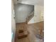 An open living room offers hardwood floors, a staircase, and a door to the outside at 1923 Fairfield Rd, Mount Gilead, NC 27306