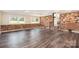 Open basement space with exposed brick, wood flooring, and ample natural light, perfect for customization at 1925 Montclair Ave, Gastonia, NC 28054