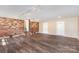 Spacious basement area with brick wall, wood-look floors, and access to laundry and bathroom facilities at 1925 Montclair Ave, Gastonia, NC 28054