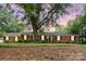 Traditional brick house with black shutters and manicured landscaping exudes timeless charm at 1925 Montclair Ave, Gastonia, NC 28054