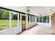 Enclosed porch offering an airy, outdoor living space, featuring white frames, screens, and ceiling fans at 1925 Montclair Ave, Gastonia, NC 28054
