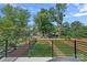 Fenced backyard with green grass and wood and brick fencing at 209 Keswick Ave, Charlotte, NC 28206