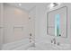 Modern bathroom featuring tile walls, a shower and tub, and updated vanity at 209 Keswick Ave, Charlotte, NC 28206