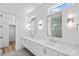 Modern bathroom with double vanity, quartz countertop, and sleek fixtures, plus a glass-enclosed shower at 209 Keswick Ave, Charlotte, NC 28206