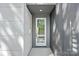 A well-lit entryway with a glass front door, offering a glimpse of the outdoors at 209 Keswick Ave, Charlotte, NC 28206