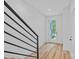 Bright entryway with hardwood floors, white walls, and modern black railing at 209 Keswick Ave, Charlotte, NC 28206