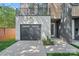 Modern home exterior with a black garage door, clean lines, and a small landscaped area at 209 Keswick Ave, Charlotte, NC 28206