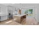 Bright open kitchen with stainless appliances, oversized island, and exterior access at 209 Keswick Ave, Charlotte, NC 28206