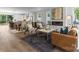 Open-concept living room with a fireplace, modern furniture, and wood floors overlooking the kitchen and dining area at 209 Keswick Ave, Charlotte, NC 28206