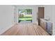 Open living space with sliding glass doors to backyard, sleek floors, and built in beverage refrigerator at 209 Keswick Ave, Charlotte, NC 28206