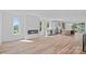 Open floor plan featuring wood floors, modern fireplace, and kitchen with stainless appliances at 209 Keswick Ave, Charlotte, NC 28206