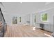 Spacious living room with modern fireplace, beverage refrigerator, sleek floors, and great natural light at 209 Keswick Ave, Charlotte, NC 28206