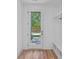 Mudroom area with hardwood floors, storage cubbies and a door to the backyard at 209 Keswick Ave, Charlotte, NC 28206