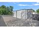 Wide roof deck with wood-look decking, door to interior, and tree views at 209 Keswick Ave, Charlotte, NC 28206