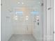 Glass-enclosed shower with dual shower heads, sleek fixtures, and tiled walls with lighting at 209 Keswick Ave, Charlotte, NC 28206