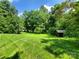 Beautiful backyard with mature trees providing shade and privacy at 2104 Farmbrook Dr, Statesville, NC 28625