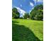 Expansive backyard featuring a lush green lawn and mature trees at 2104 Farmbrook Dr, Statesville, NC 28625