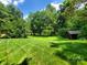 Beautiful backyard with mature trees providing shade and privacy at 2104 Farmbrook Dr, Statesville, NC 28625